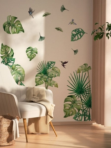 Detail of tropical green leaf and bird wall stickers in a minimalist living room setting