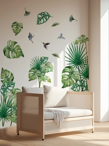 Detail of watercolor tropical leaves and bird wall stickers in a cozy sunlit room