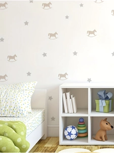 Detail of starry rocking horse wall stickers in a bright, modern nursery room setting
