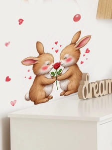 Détail de stickers muraux lapins et rose rouge sur un mur blanc de chambre