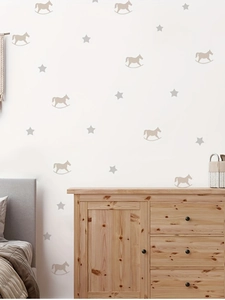 Detail of taupe rocking horse and star wall stickers on a clean white wall in nursery room