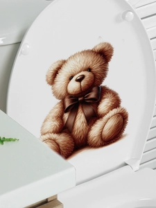Detail showing a 3D brown teddy bear decal on a white bathroom toilet lid surface