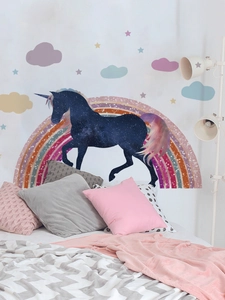 Detail of galaxy unicorn and rainbow wall decals in a cozy bedroom scene