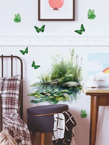 Detail of hand-painted lotus wall stickers with green butterflies in a cozy bedroom