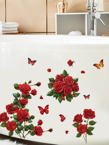Detail of red rose and butterfly wall stickers applied on a white bathtub surface