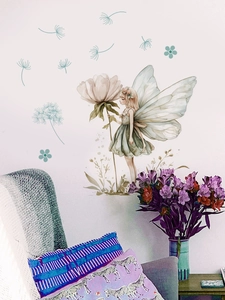 Detail of floral fairy wall sticker with dandelions in a cozy living room setup