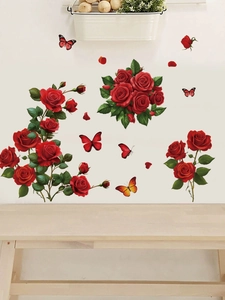 Detail of red rose and butterfly wall decals on a cream wall with a wooden bench