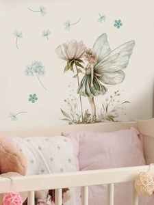 Detail of a fairy wall sticker with watercolor white flowers in a cozy nursery room