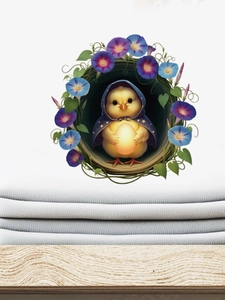 Detail of a cartoon duck wall sticker on white fabric over a light wood surface