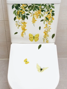 Detail of yellow flower and butterfly self-adhesive waterproof stickers on a toilet tank