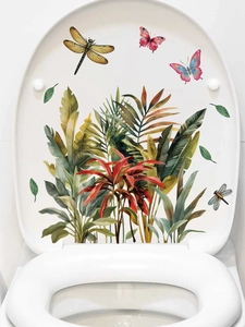 Detail of tropical plant toilet lid stickers with green leaves, butterflies and dragonflies