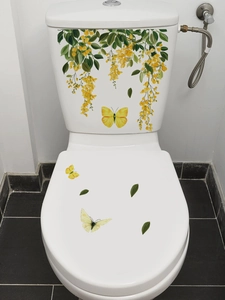 Detail of yellow flower vine and butterfly waterproof PVC decals on a white toilet