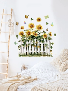 Detail of self-adhesive sunflower wall stickers with white fence and butterflies on white wall
