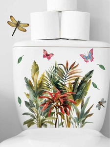 Detail of tropical plant wall stickers with leaves and butterflies on a white toilet tank