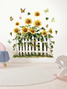 Detail of sunflower and butterfly wall stickers with white fence on clean home wall