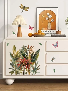 Detail of tropical plant wall stickers with butterflies on a white minimalist cabinet