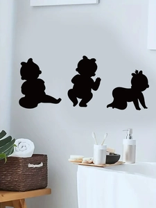 Detail of three black baby silhouette wall decals in a modern clean bathroom setting
