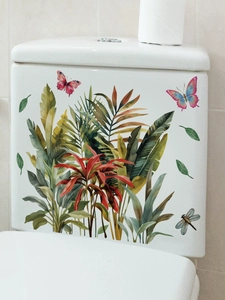 Tropical green leaves and butterfly wall stickers on white bathroom toilet tank surface