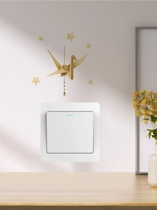 Detail of white modern light switch with blue indicator and golden crane wall stickers