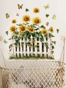 Detail view of sunflower and butterfly wall decals applied above a baby cradle in a room