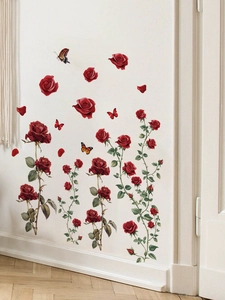 Detail of red rose wall decals with butterflies and petals on a white indoor wall