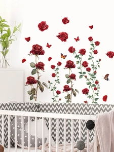 Detail of red rose wall stickers and butterflies applied on white bedroom wall