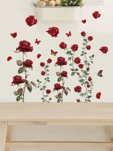 Detail of red rose wall decals with green leaves and butterflies on a white living room wall