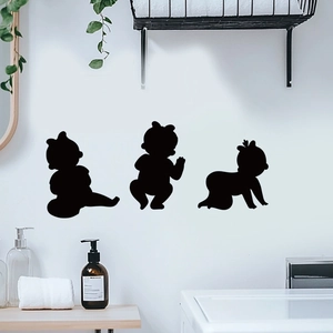 Three-piece black baby silhouette wall decals showing sitting and crawling poses on white wall