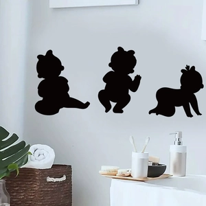Three minimalist black baby silhouette wall decals displayed on a white nursery wall