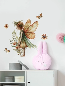 Detailed view of watercolor forest fairy wall decals in a cozy nursery room setting