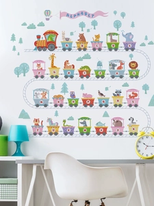 Detail of colorful alphabet animal train wall decals in a modern nursery interior
