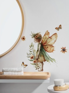 Detail of forest fairy wall sticker with butterfly wings on white wall in home decor
