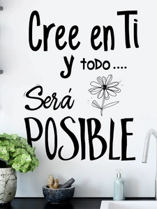 Detail of black adhesive wall decal Cree en Ti Spanish motivational quote with daisy flower