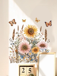 Close-up of sunflower and butterfly wall stickers with watercolor textures on a wall