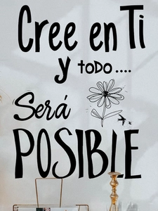 Detail of Spanish wall decal 'Cree en Ti' with hand-drawn flower on a white wall