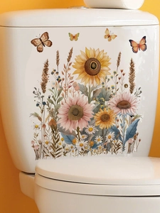 Detail view of sunflower and butterfly stickers on a white ceramic toilet tank
