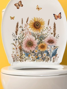 Macro detail of sunflower and butterfly stickers applied on a white toilet lid