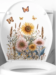 Close-up of watercolor sunflower and butterfly self-adhesive decals on a white toilet lid