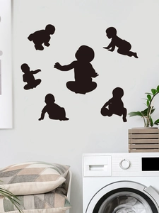 Detailed view of black baby silhouette wall stickers in various crawling poses for home decor