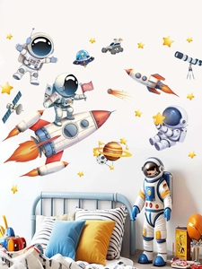 Detail showing astronaut wall decals with rocket and planet stickers in kids bedroom