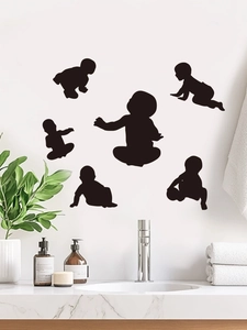 Detailed view of six black baby silhouette wall stickers in a clean bathroom setting