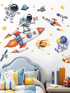 Cartoon astronaut and planet wall stickers applied over a blue bed in a kid's bedroom
