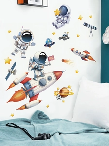 Detailed view of astronaut and rocket wall stickers applied to a children bedroom wall
