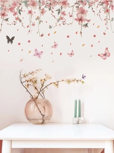 Close-up of pink flower vine wall decals with colorful butterflies and falling petals