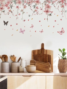 Detail view of pink cherry blossom wall stickers with butterflies in a cozy kitchen setting