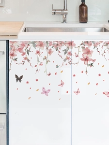 Detail view of pink cherry blossom wall stickers with butterflies on kitchen cabinets