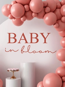 Close-up of Baby in Bloom wall signage with pink balloons for baby shower decor