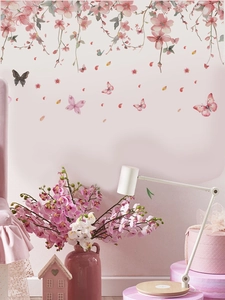Detail of pink cherry blossom wall stickers with butterflies on a living room wall