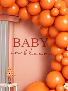 Detail of Baby in Bloom orange balloon arch kit with backdrop and floral party decorations