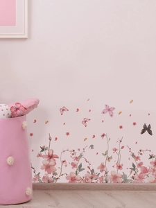 Detailed close-up of pink flower and butterfly wall stickers on a soft pink wall